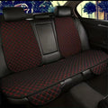 Car seat cover with red stitching on a car interior background